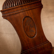 Load image into Gallery viewer, Close-up of a wooden clock with intricate carvings on a beige background