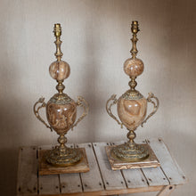 Load image into Gallery viewer, Two ornate lamps on a wooden table against a plain wall.
